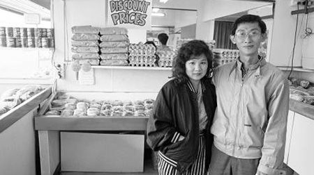 Black and white image of a couple standing in a store.