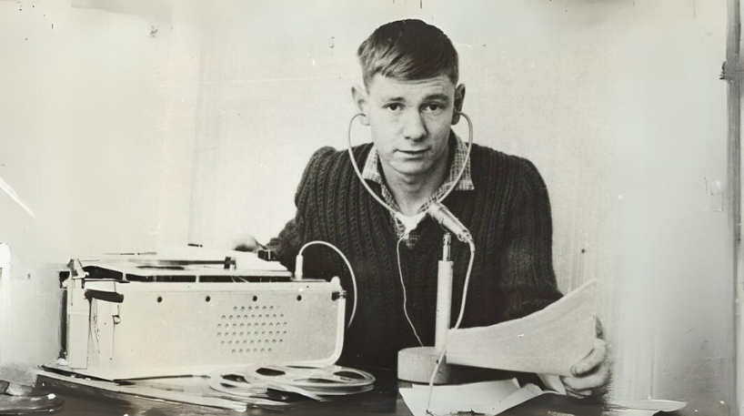 A black and white photo of a man using recording equipment. This is part of the Auckland Council Libraries heritage collections.