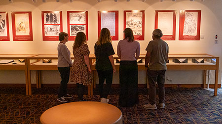 A group of people viewing an exhibition.
