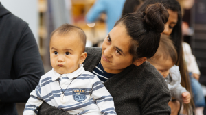 Toddler and mother engaged in an event for tamariki
