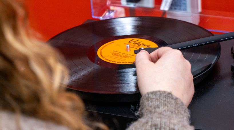 Person using a vinyl record player
