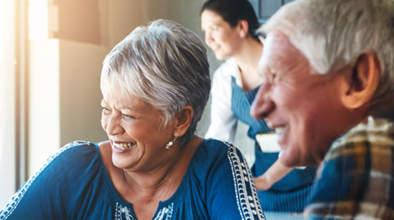 A silver-haired man and woman smiling 