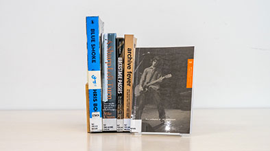 Books in a row with one front-facing book cover titled Betchadupa and Good Pop