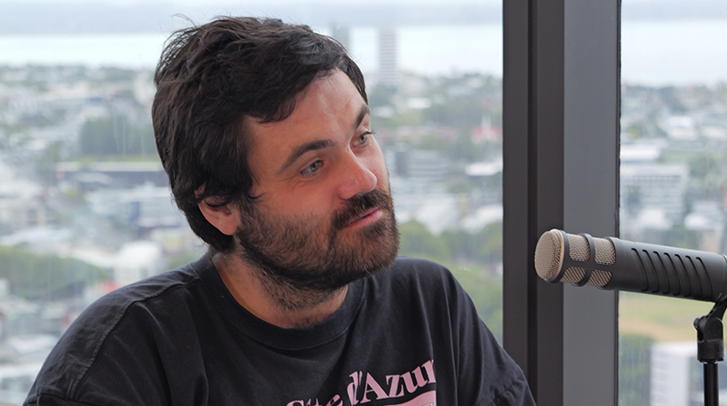 Dan Goodwin speaking into a microphone during the podcast.