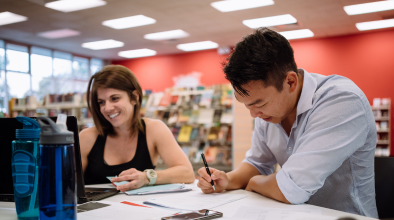 Two people working together at the library
